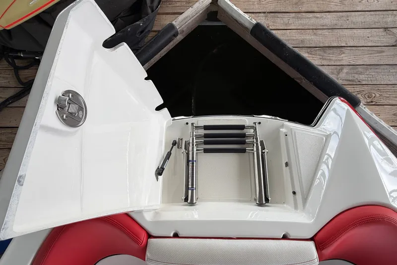 Slide: The Image of 2017 MasterCraft X23 boat with open storage compartment and ladder on deck. - 24