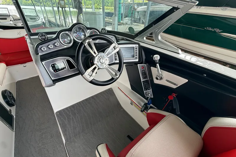 Slide: The Image of Interior view of a 2017 MasterCraft X23 boat cockpit with steering wheel and controls. - 30