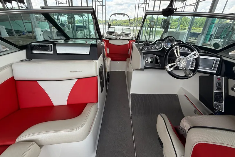 Slide: The Image of Interior of a 2017 MasterCraft X23 boat with red and white seating. - 28