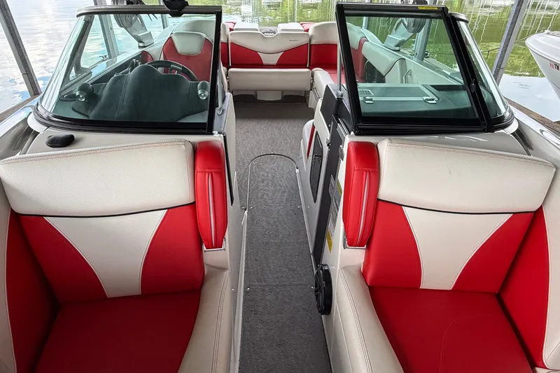 Slide: The Image of 2017 MasterCraft X23 boat interior with red and white seating, sleek design. - 22