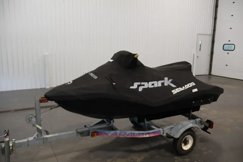 Slide: The Image of 2014 Sea-Doo Spark 3up jet ski covered on trailer in garage. - 12