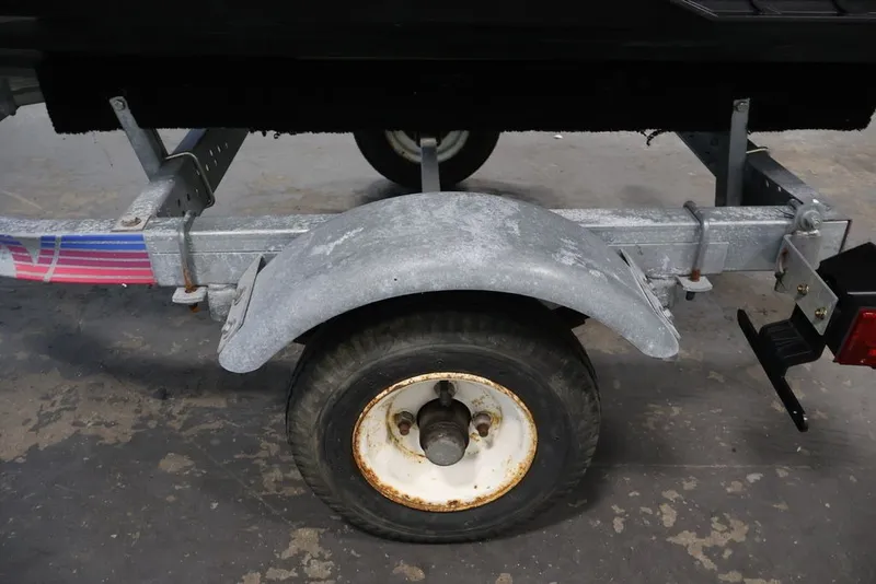 Slide: The Image of Trailer wheel for 2014 Sea-Doo Spark 3up, featuring a metal fender and rusted rim. - 20