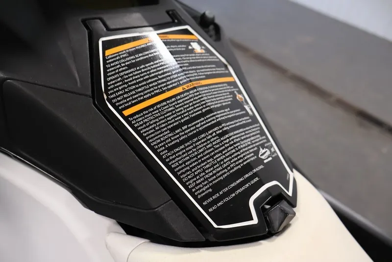 Slide: The Image of 2014 Sea-Doo Spark 3up warning label on black and white body panel. - 18