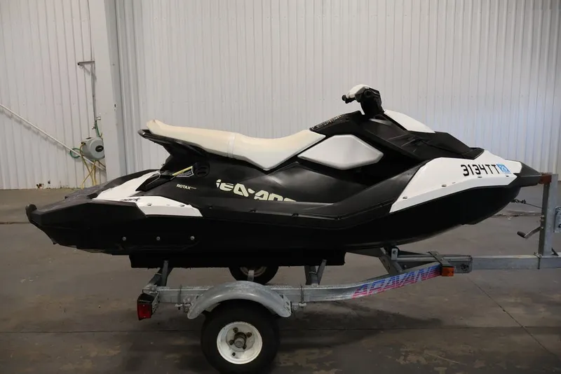 Slide: The Image of 2014 Sea-Doo Spark 3up jet ski on trailer in indoor setting. - 4