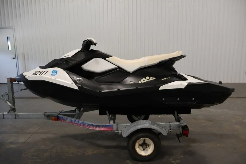 Slide: The Image of 2014 Sea-Doo Spark 3up jet ski on trailer in indoor setting. - 16