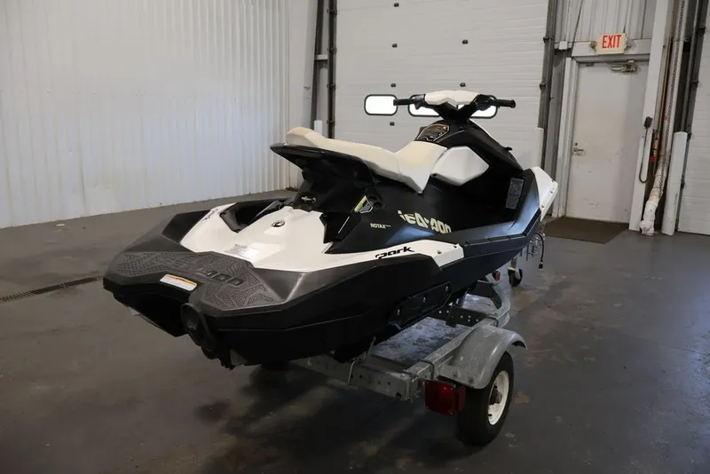 Slide: The Image of 2014 Sea-Doo Spark 3up jet ski on trailer in indoor garage setting. - 3