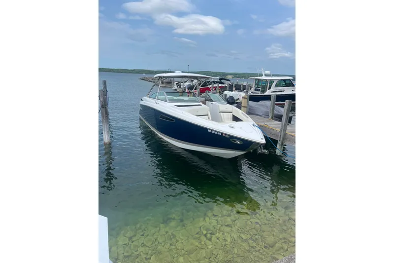 The Image of 2020 Cobalt R35 boat docked on clear water under a partly cloudy sky. - 0