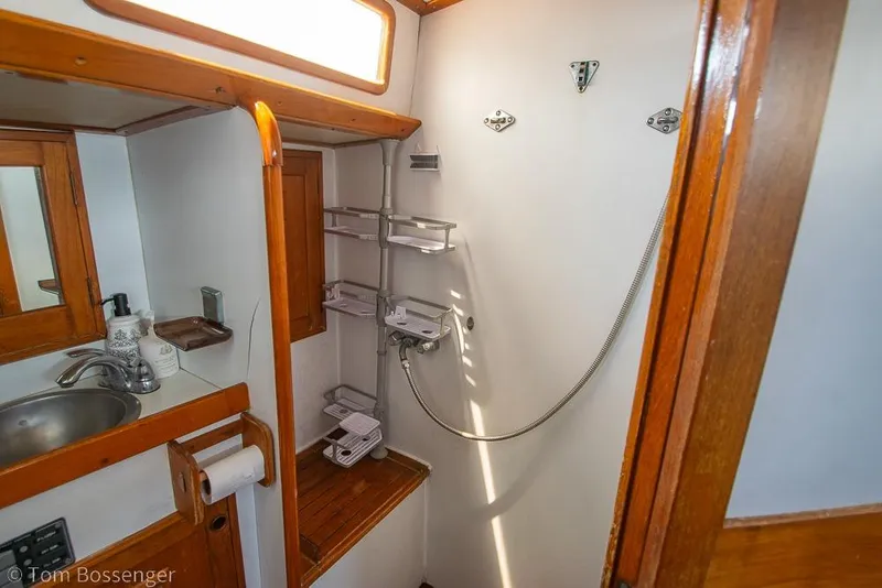 Slide: The Image of 1984 Cheoy Lee Pedrick 41 yacht bathroom with sink, shower, and wooden accents. - 19
