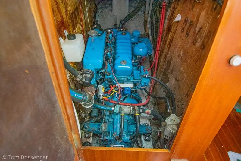 Slide: The Image of Engine room of a 1984 Cheoy Lee Pedrick 41 sailboat, featuring a blue marine engine. - 32