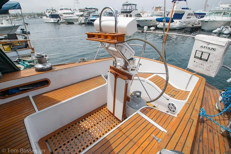 Slide: The Image of 1984 Cheoy Lee Pedrick 41 sailboat cockpit with wooden deck and steering wheel at marina. - 5