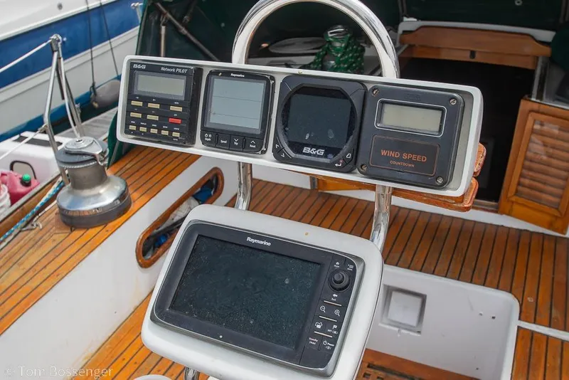 Slide: The Image of Cockpit instruments on a 1984 Cheoy Lee Pedrick 41 sailboat, featuring navigation and wind speed displays. - 24
