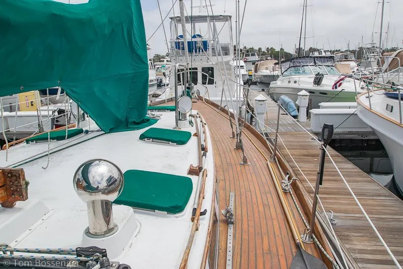 Slide: The Image of 1984 Cheoy Lee Pedrick 41 sailboat docked, featuring teak deck and green sail cover. - 27