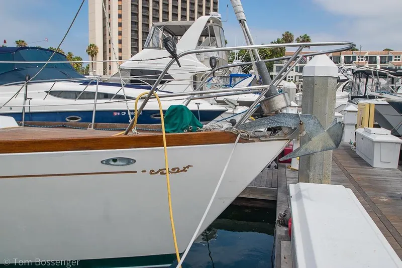 Slide: The Image of 1984 Cheoy Lee Pedrick 41 yacht docked at marina, featuring wooden trim and anchor. - 3