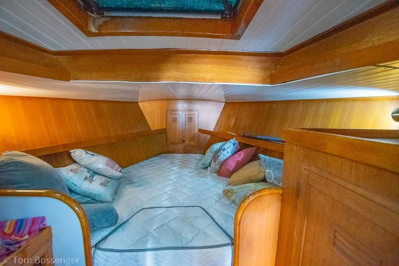 Slide: The Image of Cozy cabin interior of 1984 Cheoy Lee Pedrick 41 sailboat with wooden finish and cushions. - 14