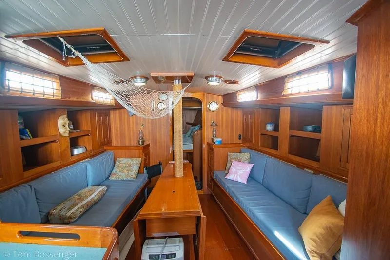 Slide: The Image of Interior of 1984 Cheoy Lee Pedrick 41 yacht with wooden furnishings and blue seating. - 11