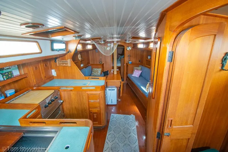 Slide: The Image of Interior of 1984 Cheoy Lee Pedrick 41 sailboat with wooden furnishings and cozy seating. - 7