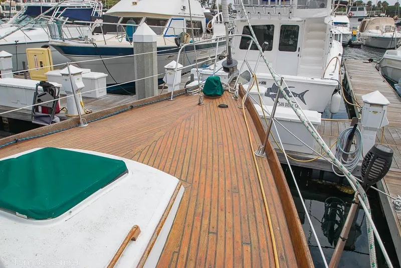 Slide: The Image of 1984 Cheoy Lee Pedrick 41 sailboat docked, showcasing wooden deck and marina surroundings. - 28