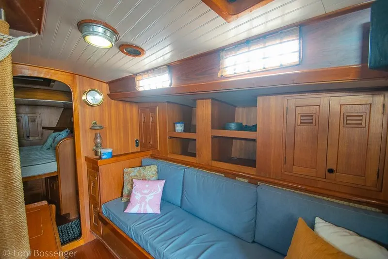 Slide: The Image of 1984 Cheoy Lee Pedrick 41 yacht interior with wooden cabinetry and blue seating. - 12