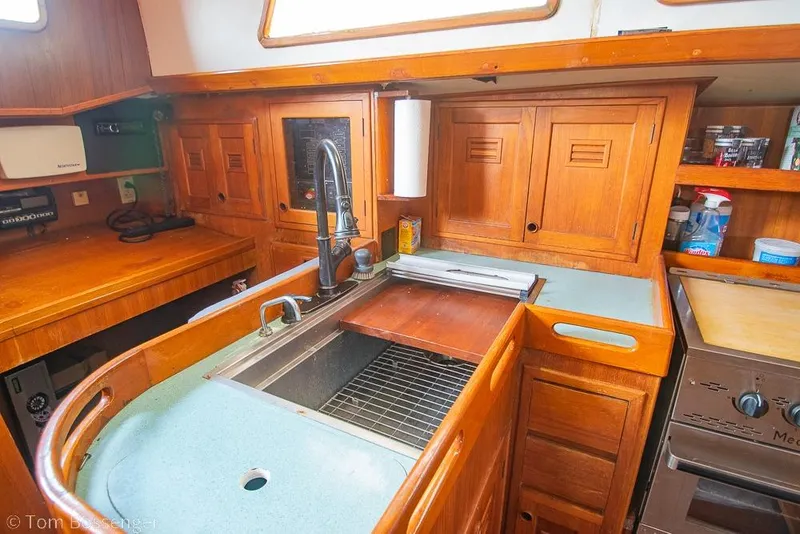 Slide: The Image of 1984 Cheoy Lee Pedrick 41 yacht kitchen with wooden cabinets and modern sink. - 10
