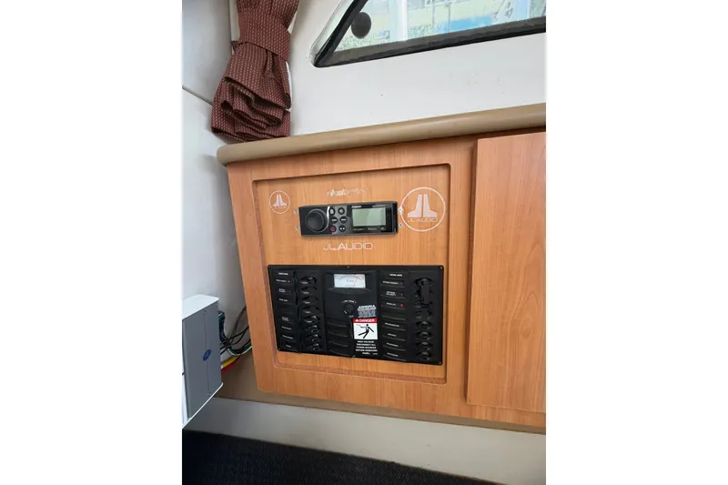 Slide: The Image of Control panel of a 2009 Bayliner Discovery 246 boat with JL Audio system. - 11