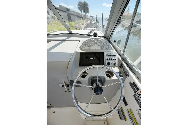 Slide: The Image of 2009 Bayliner Discovery 246 helm with Garmin navigation, steering wheel, and instrument panel. - 8