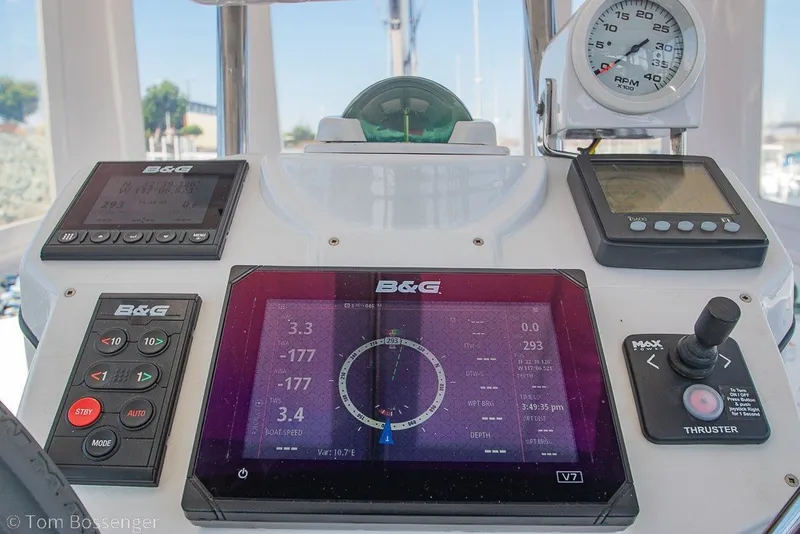 Slide: The Image of Cockpit controls of a 2009 Hunter 50 Center Cockpit sailboat with navigation instruments. - 49
