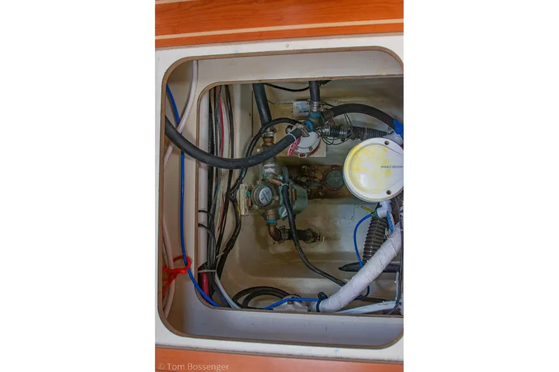 Slide: The Image of Engine compartment of 2009 Hunter 50 Center Cockpit sailboat, showing hoses and wiring. - 95