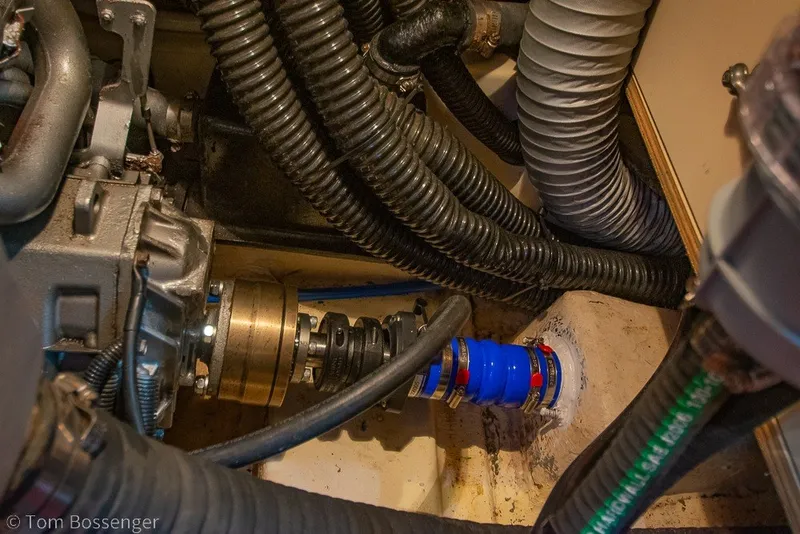 Slide: The Image of Engine compartment of 2009 Hunter 50 Center Cockpit sailboat, showing hoses and mechanical components. - 94