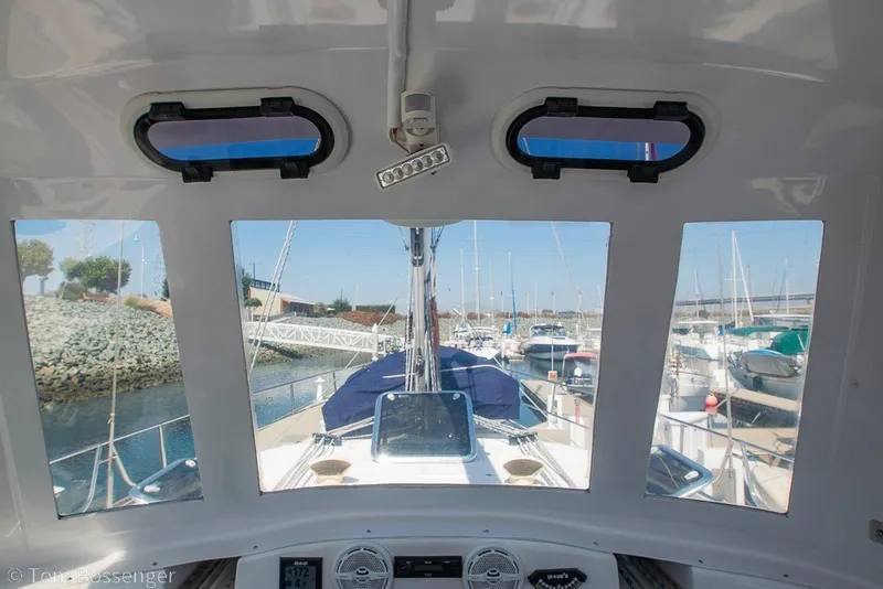 Slide: The Image of Interior view from a 2009 Hunter 50 Center Cockpit sailboat, overlooking a marina. - 66