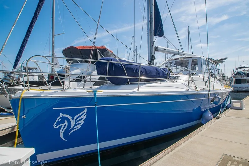 The Image of 2009 Hunter 50 Center Cockpit sailboat docked, featuring a sleek blue hull and modern design. - 0