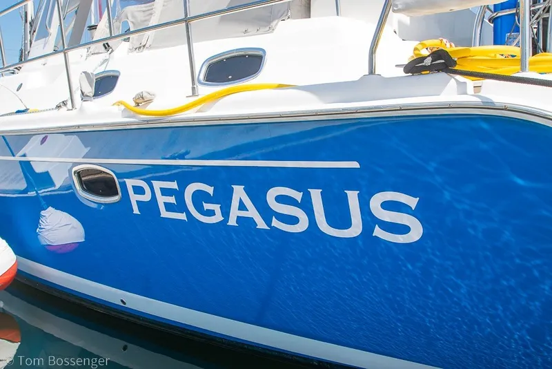 Slide: The Image of Blue Hunter 50 Center Cockpit yacht named "Pegasus," 2009 model, docked in sunlight. - 5