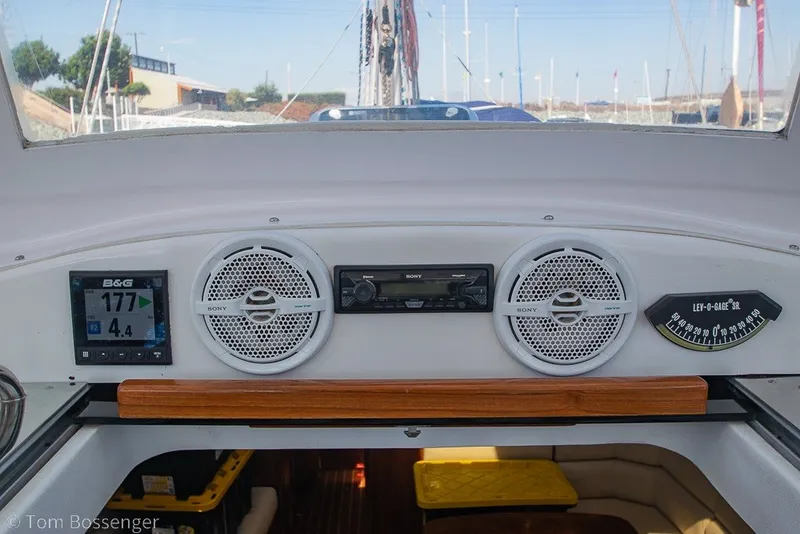 Slide: The Image of Cockpit dashboard of 2009 Hunter 50 Center Cockpit with navigation instruments and speakers. - 63