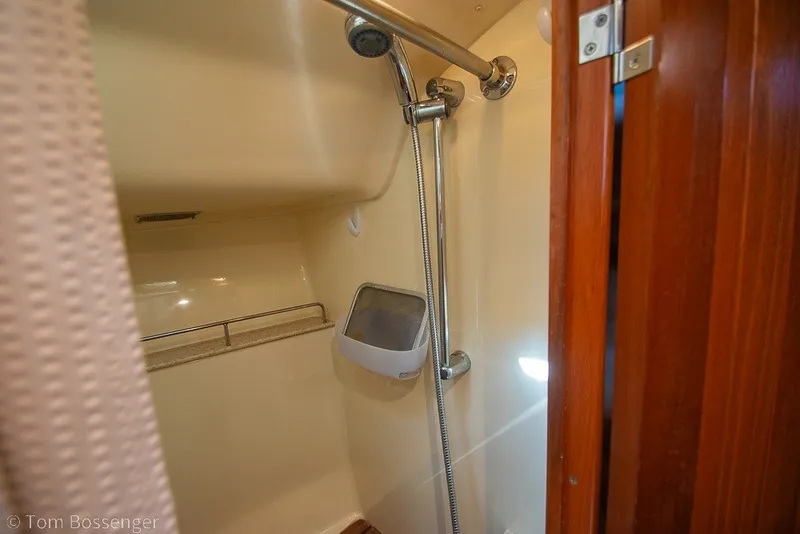 Slide: The Image of Shower area in 2009 Hunter 50 Center Cockpit yacht with wooden door and chrome fixtures. - 31