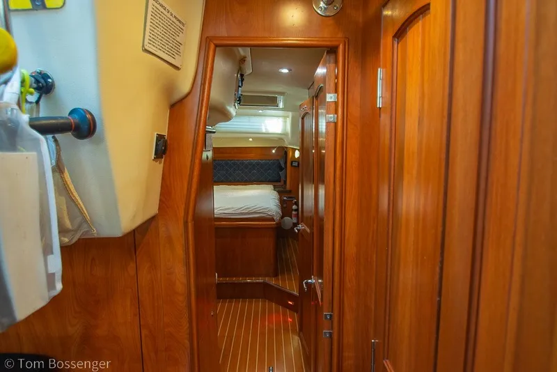 Slide: The Image of Interior view of 2009 Hunter 50 Center Cockpit yacht, featuring wooden paneling and cozy cabin. - 33