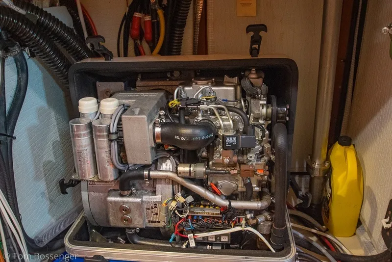 Slide: The Image of Engine compartment of a 2009 Hunter 50 Center Cockpit sailboat, showcasing detailed machinery. - 92