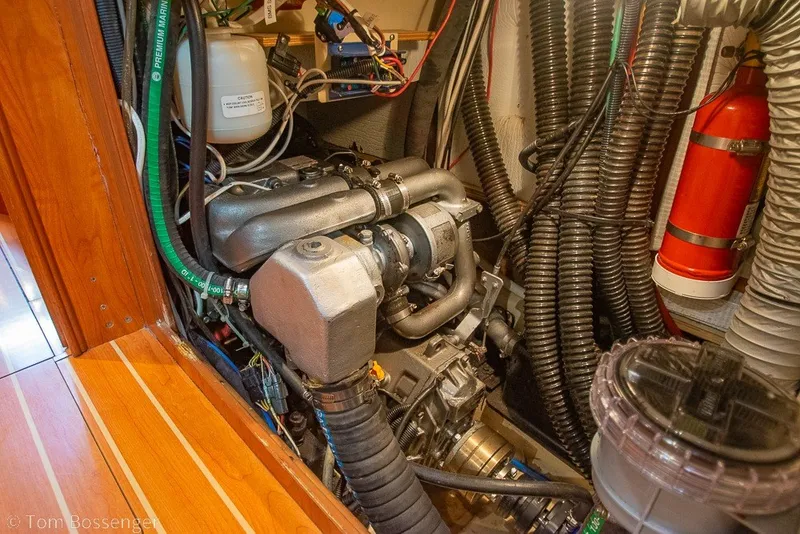 Slide: The Image of Engine room of a 2009 Hunter 50 Center Cockpit sailboat, showcasing mechanical components. - 90