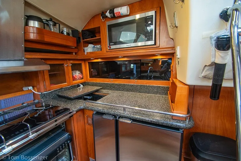 Slide: The Image of Luxurious 2009 Hunter 50 Center Cockpit yacht kitchen with modern appliances and wood cabinetry. - 13