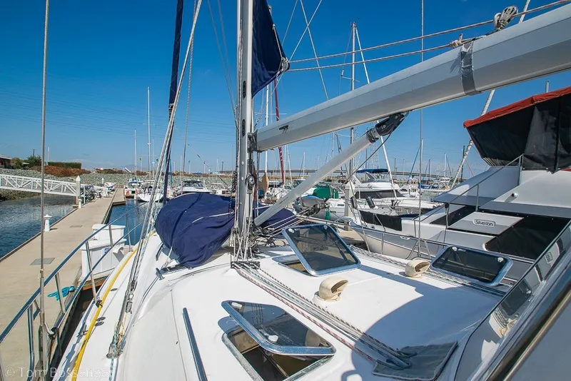 Slide: The Image of 2009 Hunter 50 Center Cockpit sailboat docked at a marina under clear blue skies. - 72