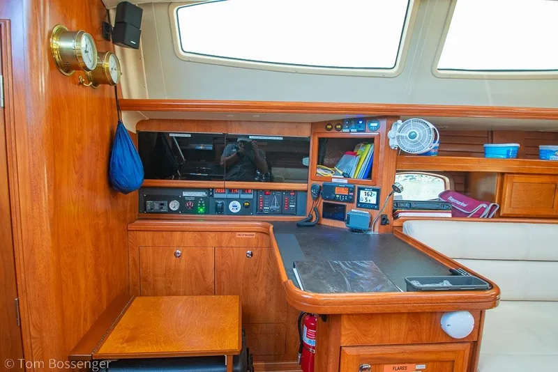Slide: The Image of Interior of 2009 Hunter 50 Center Cockpit yacht with navigation station and wooden cabinetry. - 23