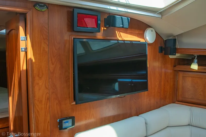 Slide: The Image of Interior of 2009 Hunter 50 Center Cockpit yacht with TV and wooden paneling. - 20
