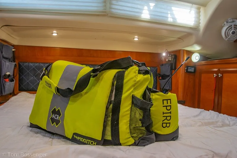 Slide: The Image of Yellow emergency bag with EPIRB on a 2009 Hunter 50 Center Cockpit yacht bed. - 91