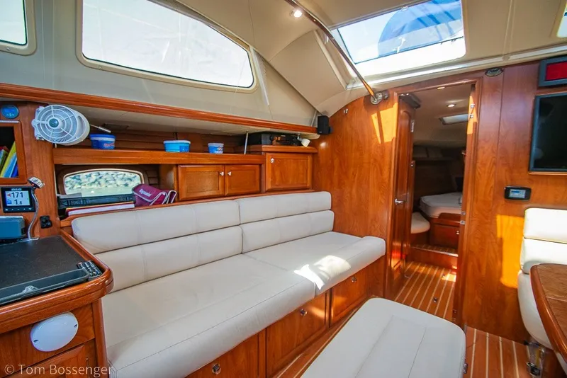 Slide: The Image of Interior of 2009 Hunter 50 Center Cockpit yacht with wooden cabinetry and beige seating. - 19