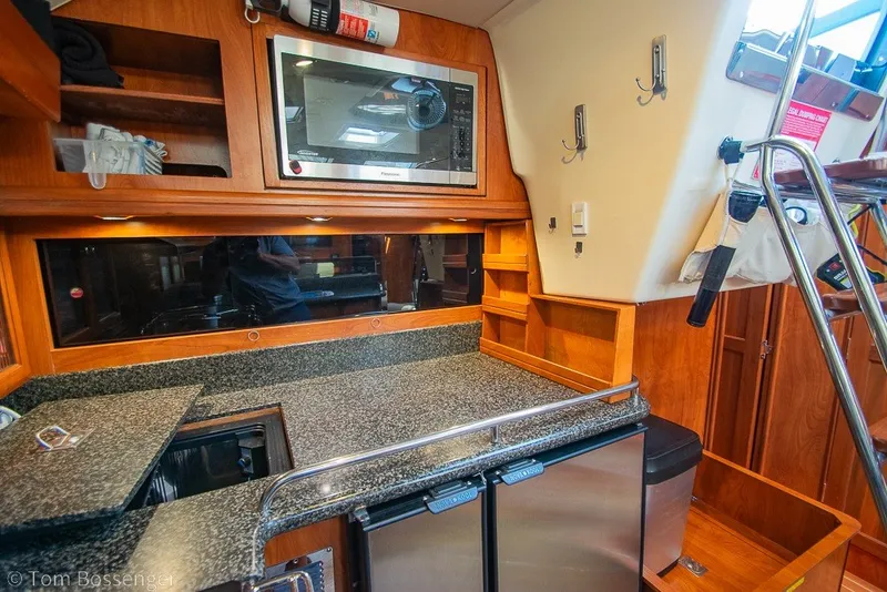 Slide: The Image of Galley kitchen in 2009 Hunter 50 Center Cockpit yacht with microwave and granite countertops. - 14