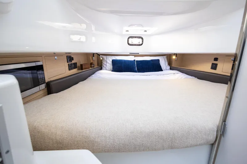 Slide: The Image of Luxurious cabin interior of 2027 Wellcraft 38 T-Top boat with cozy bedding and modern amenities. - 7