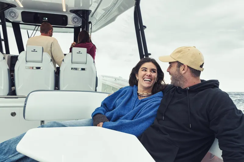 Slide: The Image of Couple enjoying a ride on a 2027 Wellcraft 38 T-Top boat. - 11