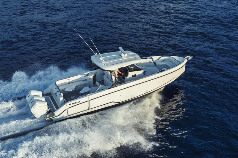 Slide: The Image of 2027 Wellcraft 38 T-Top boat cruising on open water. - 9