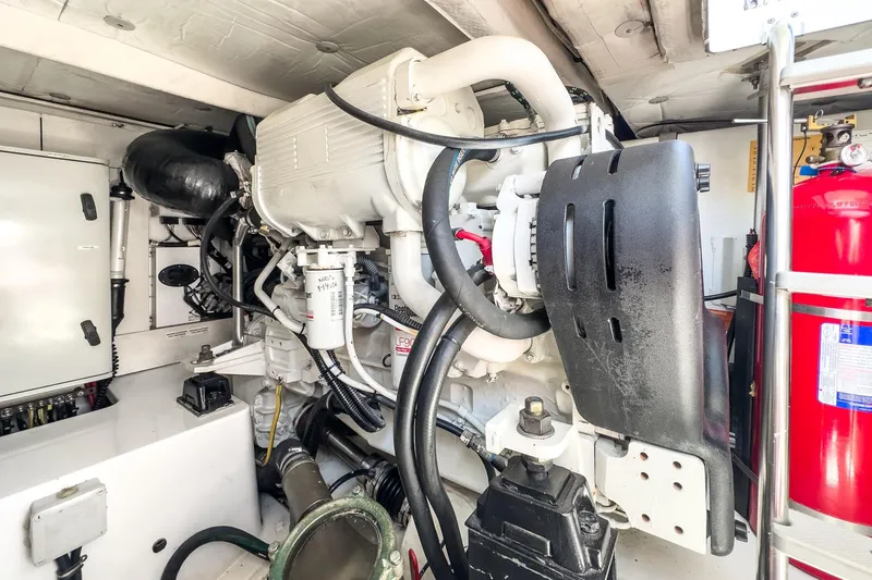 Slide: The Image of Engine room of a 2012 Azimut 48 yacht, showcasing mechanical components and fire extinguisher. - 51