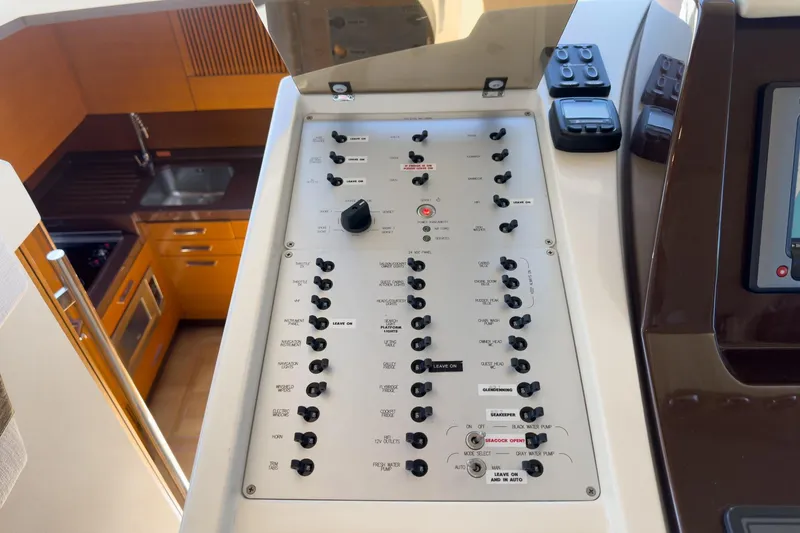 Slide: The Image of Control panel of a 2012 Azimut 48 yacht, with kitchen area visible in the background. - 33