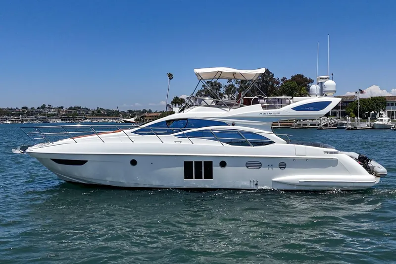 Slide: The Image of Luxury 2012 Azimut 48 yacht cruising on a sunny day in a scenic harbor. - 6