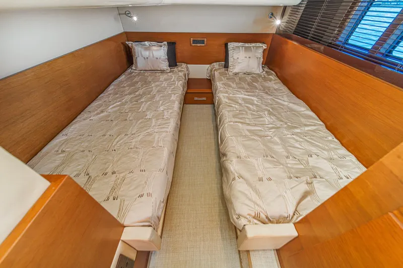 Slide: The Image of Twin cabin interior of 2012 Azimut 48 yacht with wooden finishes and cozy bedding. - 47